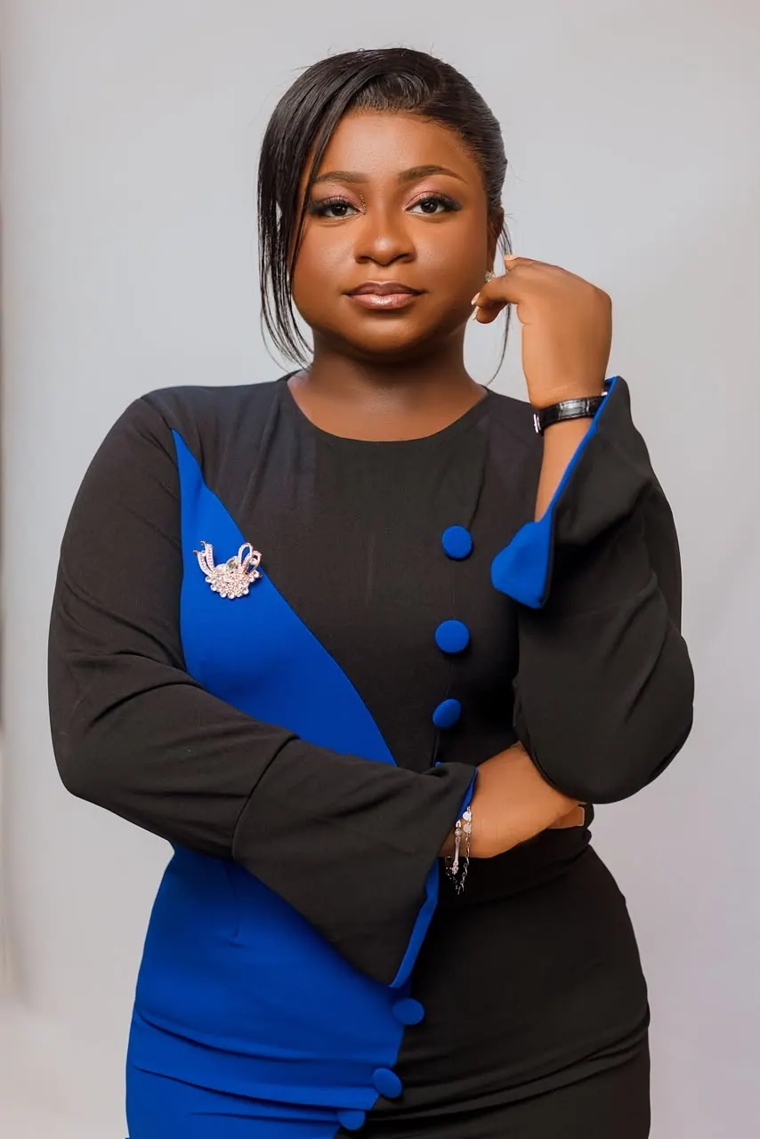 Grace Takyi in a blue and black dress